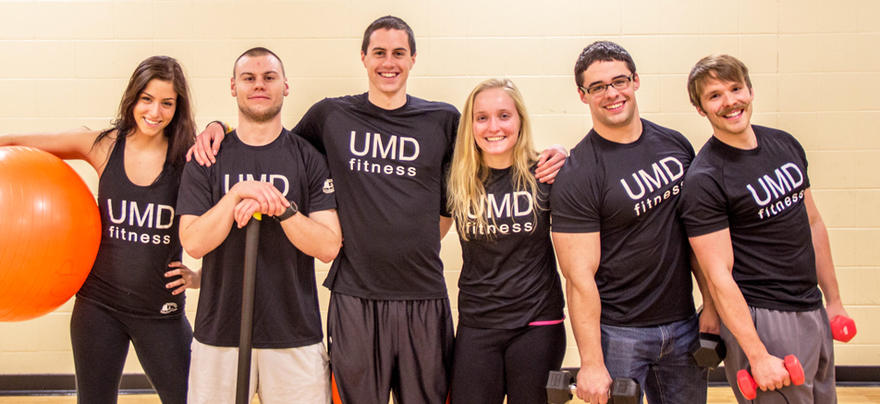 UMD personal trainers standing in a group and smiling 