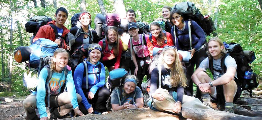 Group of smiling students out for a hike