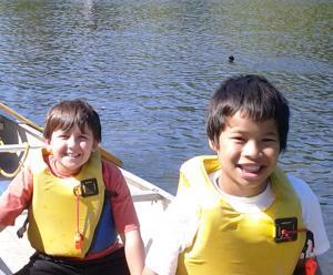 Two smilling kids in a canoe 