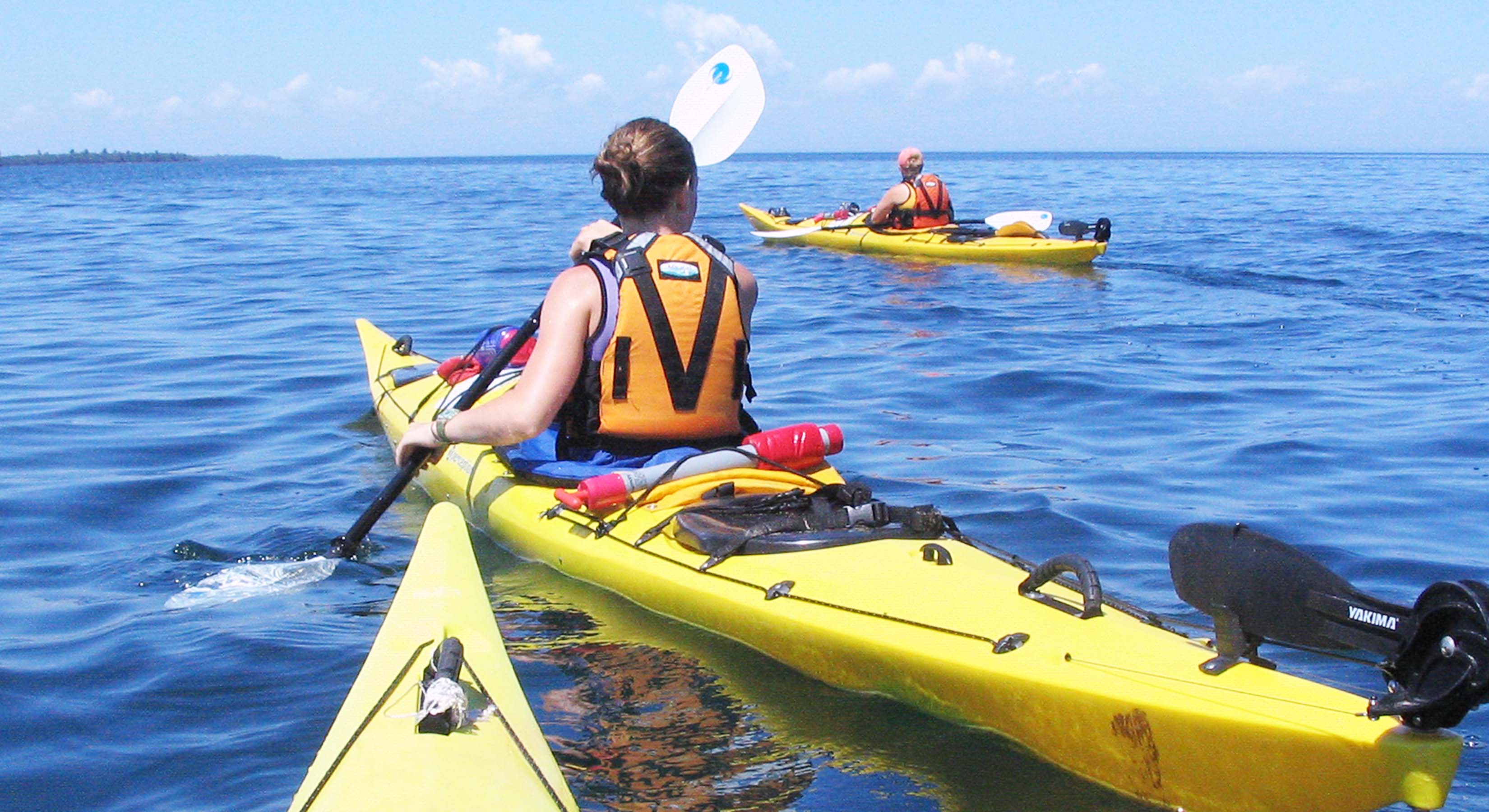 sea kayakers on Lake Superior in yellow kayaks