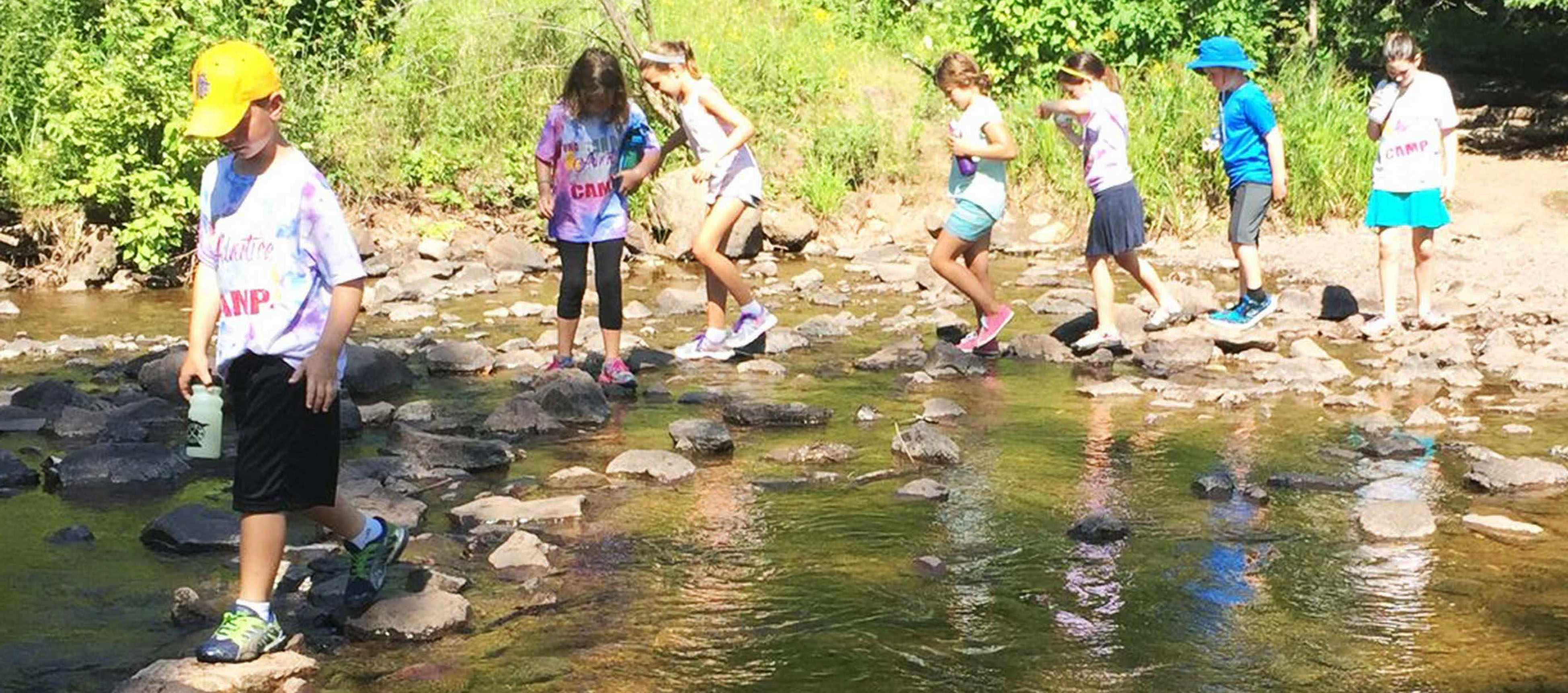 kids wading in a river