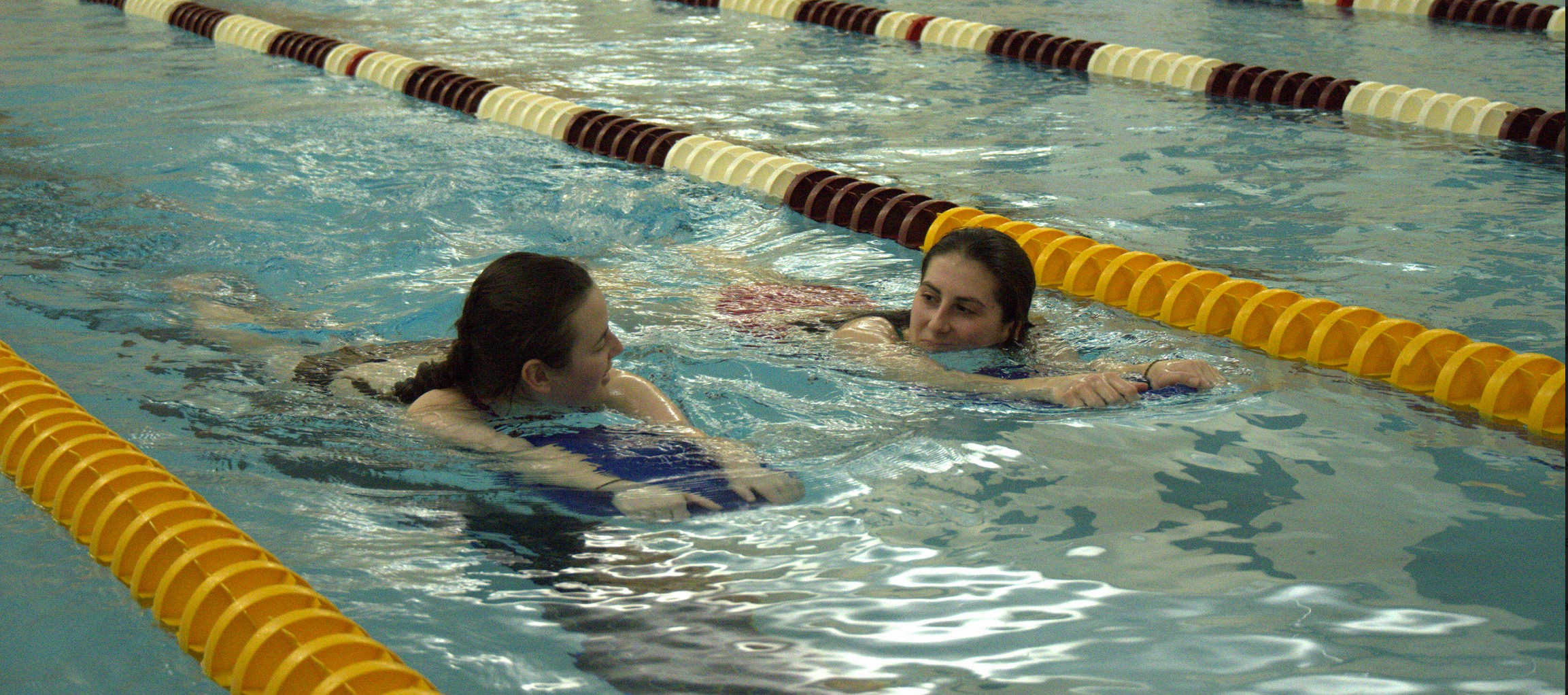 students lap swimming in the pool