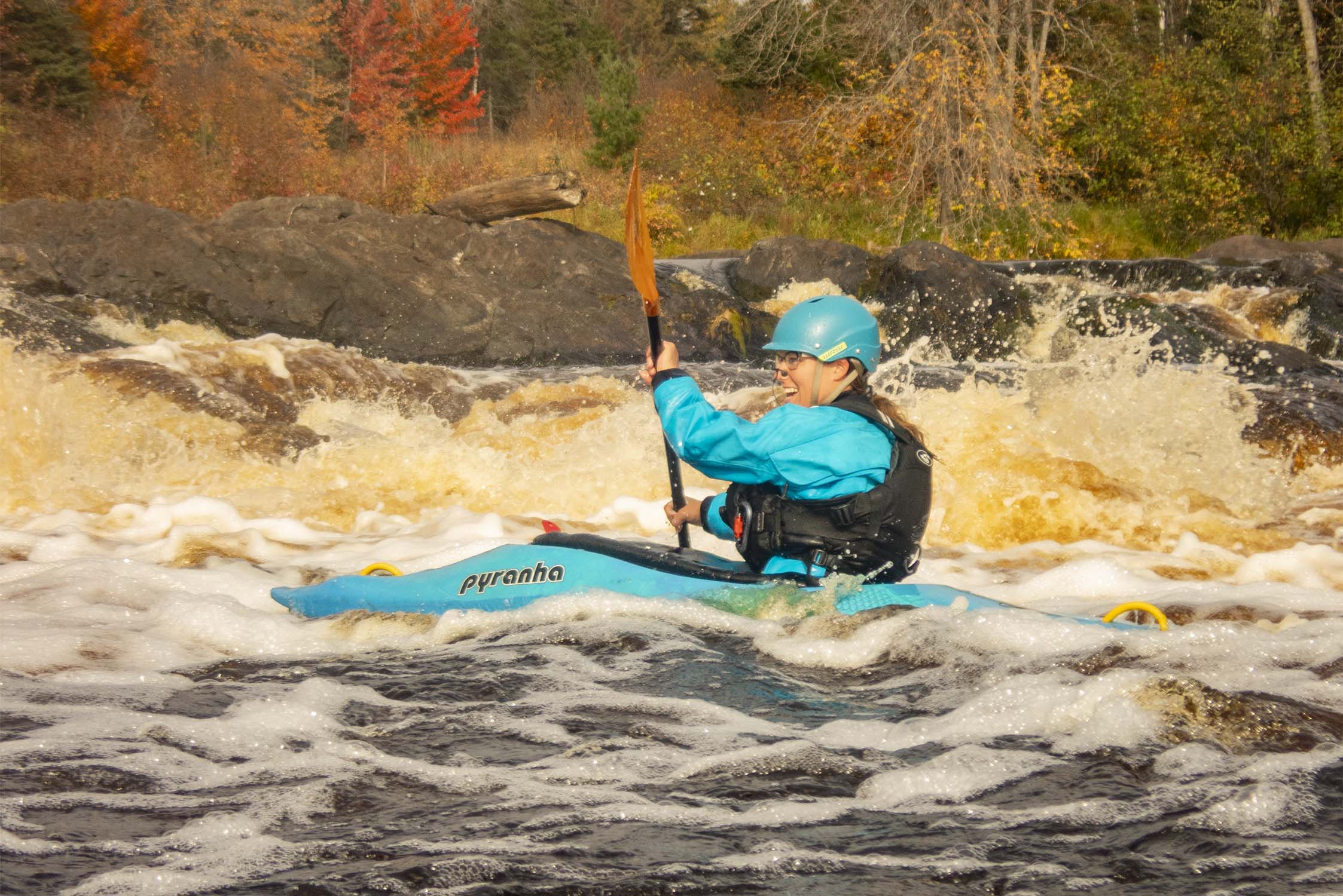 kayak paddler on a rapid