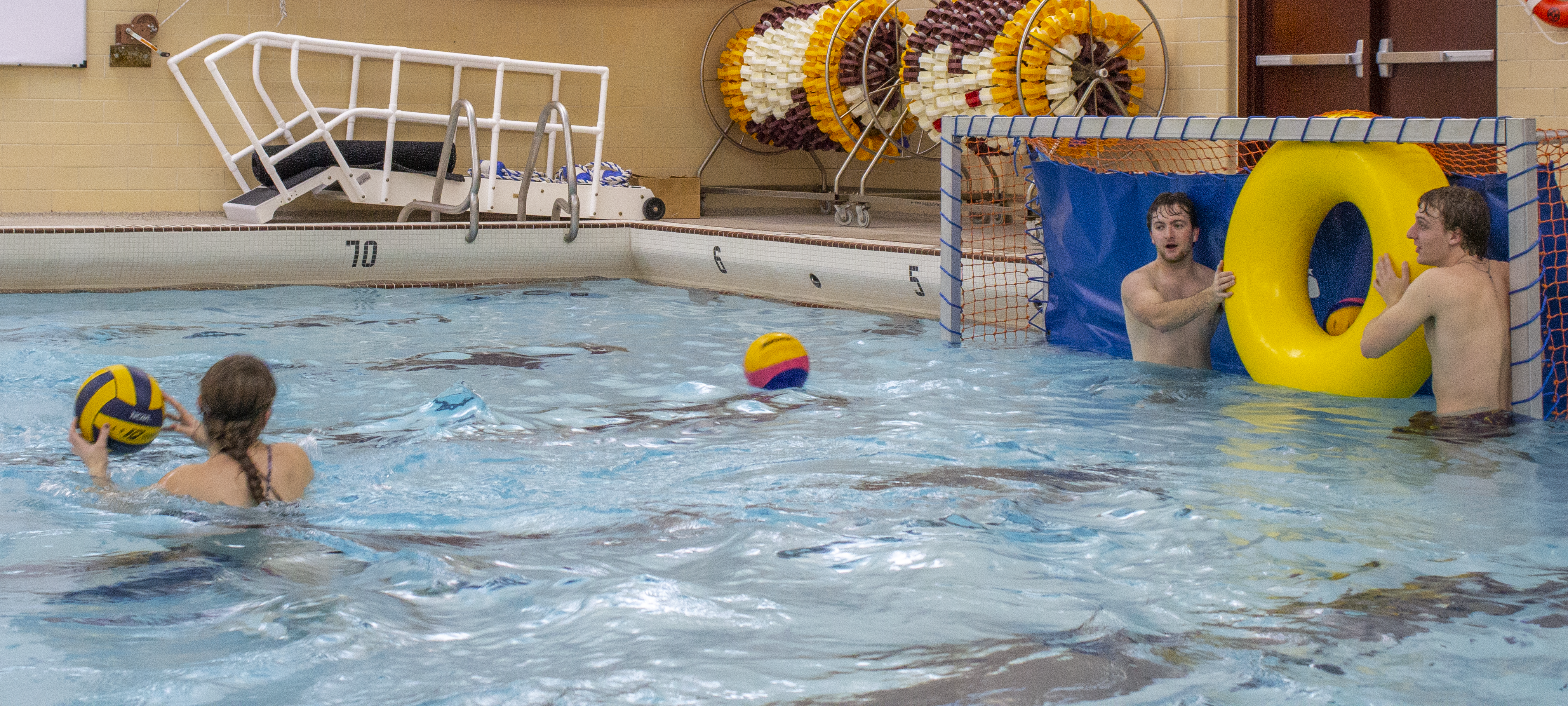 students playing water polo in the pool